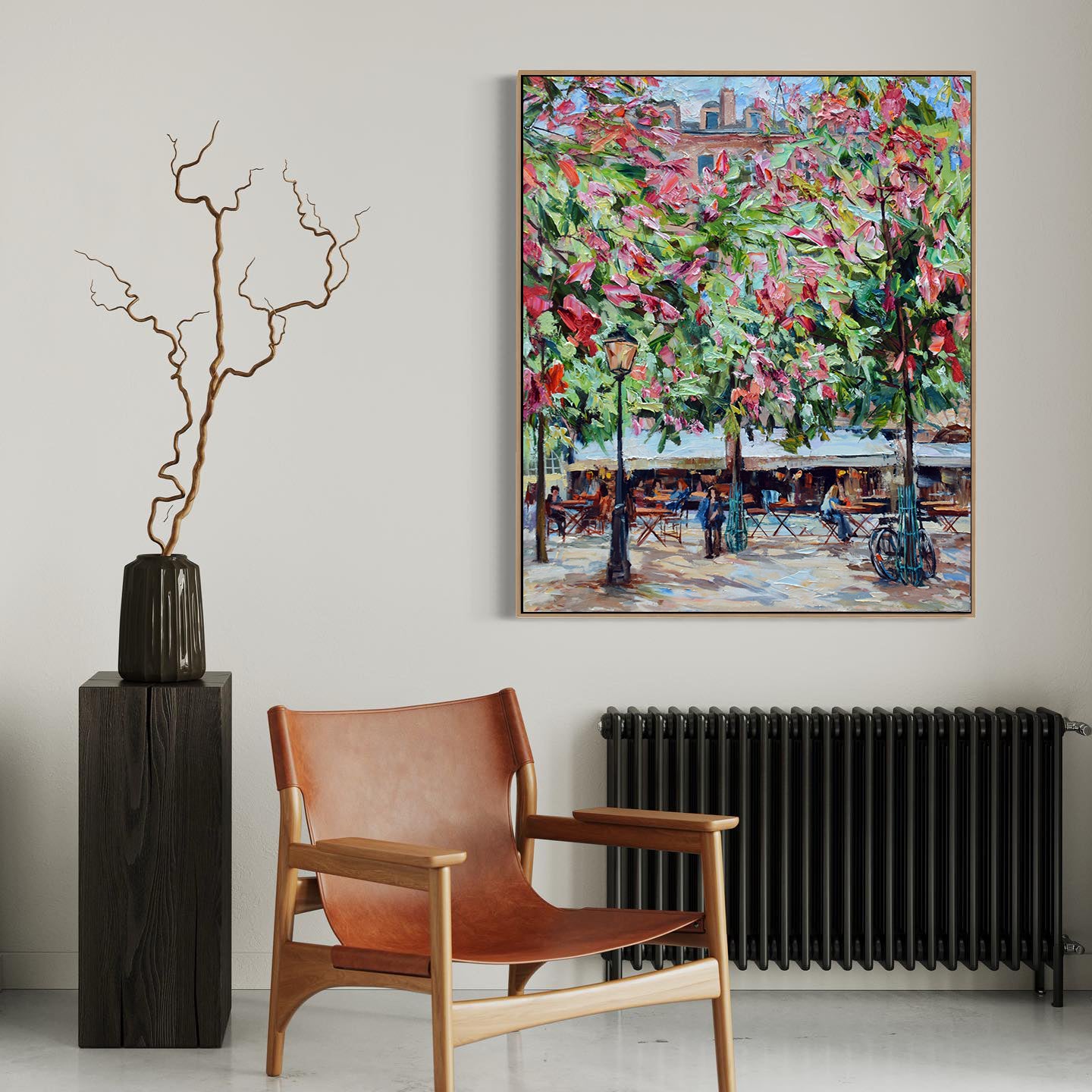 a painting hanging on a wall next to a chair