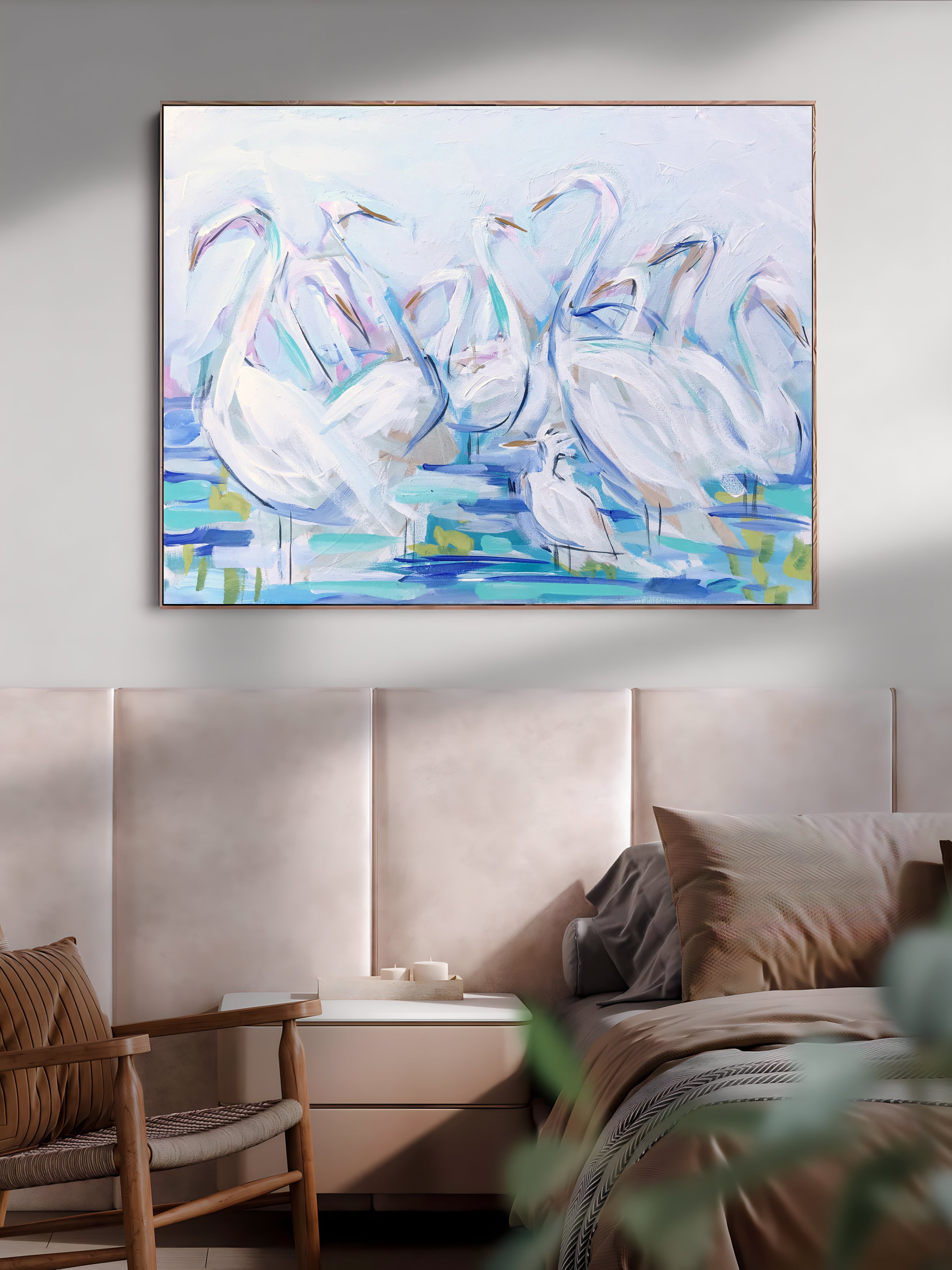 a painting of swans on a wall above a bed