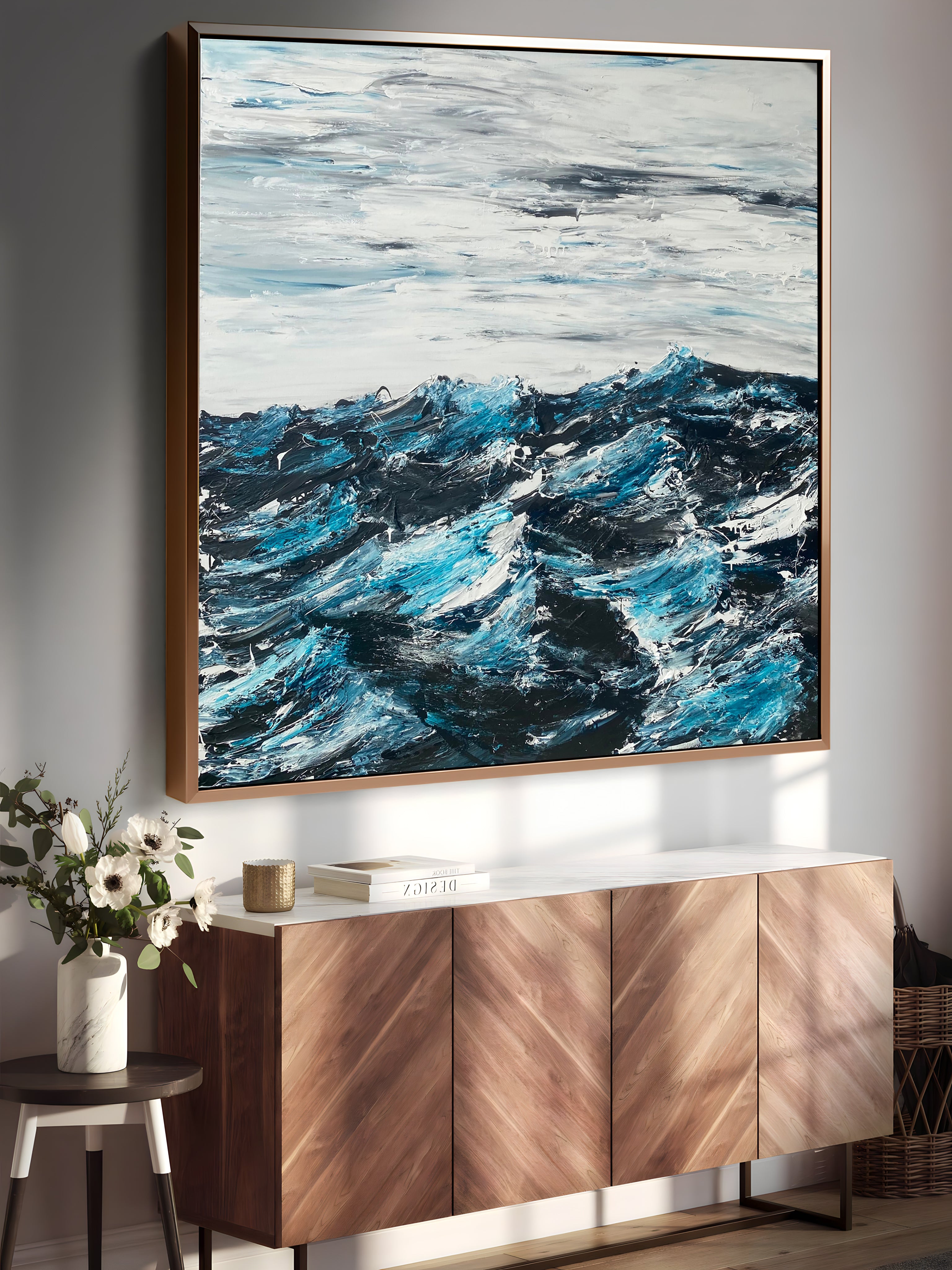 a painting hanging on a wall next to a sideboard